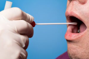 performing DNA cheek swab collection for paternity test showing simple and painless sample collection process used in Nashville Tennessee